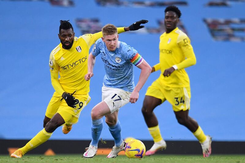 Manchester City's Kevin De Bruyne surges away from Andre-Frank Zambo Anguissa and Ola Aina of Fulham. AP