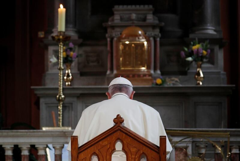 Pope Francis prays inside St Mary's Pro Cathedral. Reuters