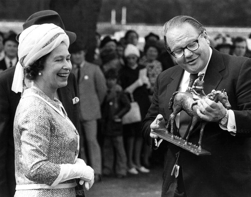 Nelson Bunker Hunt, seen here receiving the winners trophy from Queen ELizabeth, owned hundreds of race horses. Central Press / Getty Images