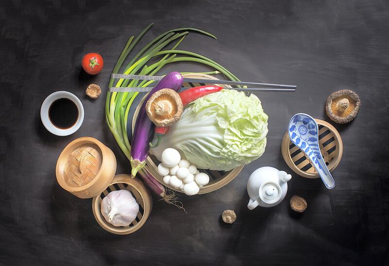 Flat lay Chinese vegan food and seasoning sauce still life with text space. Moody rustic background. Healthy eating lifestyle conceptual image.