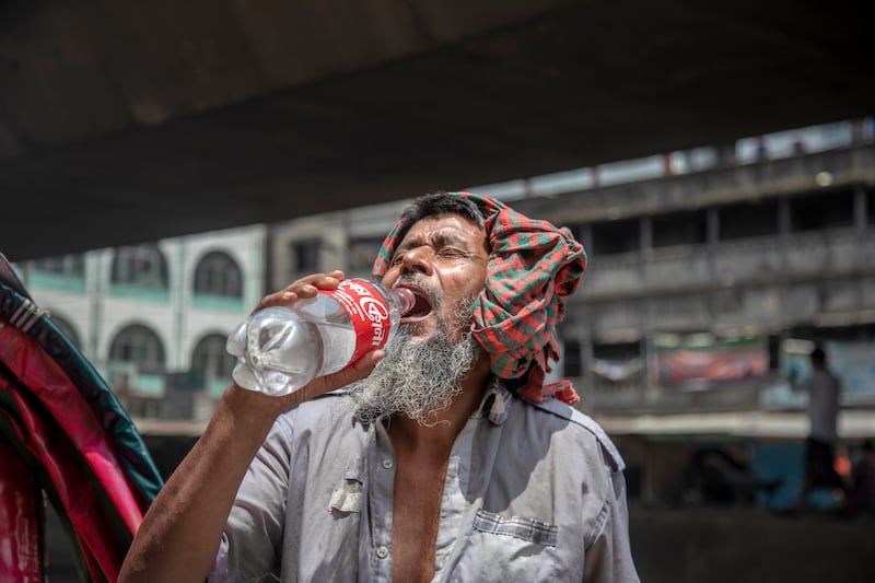 A man drinks water during a heatwave in Dhaka as temperatures soar across the country. EPA