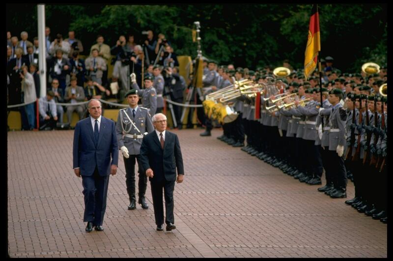 (L-R) West German Chancellor Helmut Kohl and East German leader Erich Honecker being greeted by brass band during visit to Bonn.  (Photo by Chris Niedenthal/The LIFE Images Collection via Getty Images/Getty Images)