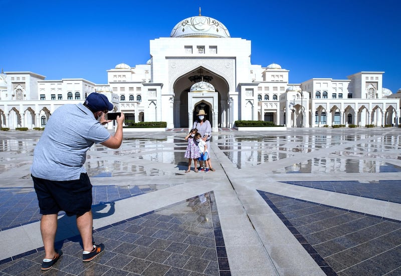 Abu Dhabi, United Arab Emirates, October  20, 2020.   A family takes a souvenir photo on the first day of the reopening of Qasr Al Watan on Tuesday with strict measures in place to limit the spread of Covid-19.
 Victor Besa/The National
Section:  NA
Reporter: