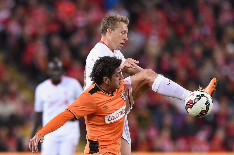 Lucas Leiva of Liverpool jumps at the ball against Dimitri Petratos of Brisbane Roar during their international friendly on Friday. Matt Roberts / Getty Images