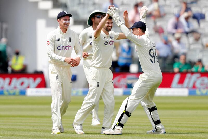 England's Mark Wood celebrates with teammates after New Zealand's Henry Nicholls was caught on the boundary for 61. AFP