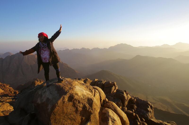 A tourist poses for a photo on the top of Mount Sinai. EPA