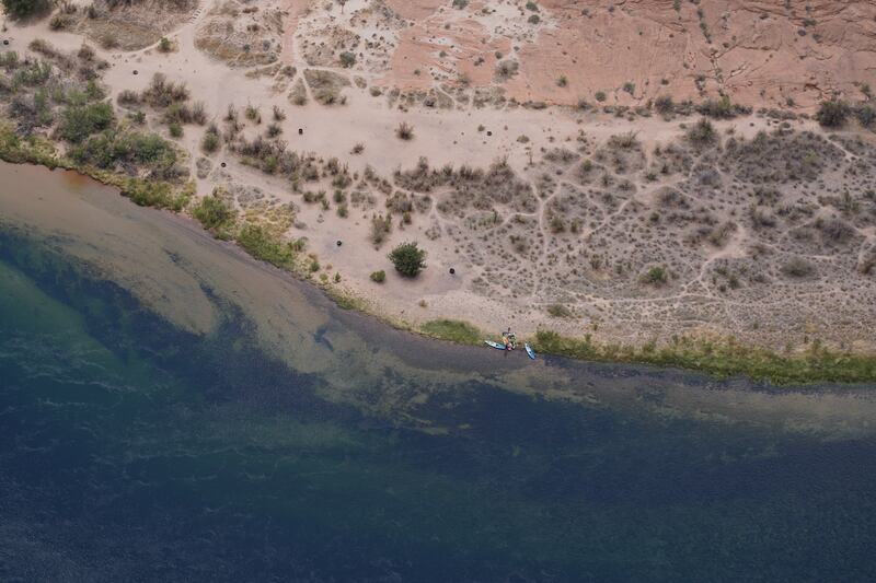 Kayakers rest on the dry shore of the Colorado River in Horseshoe Bend.