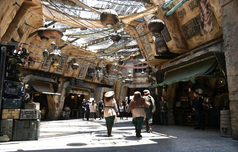 Characters stroll through the marketplace at the Black Spire Outpost. AP