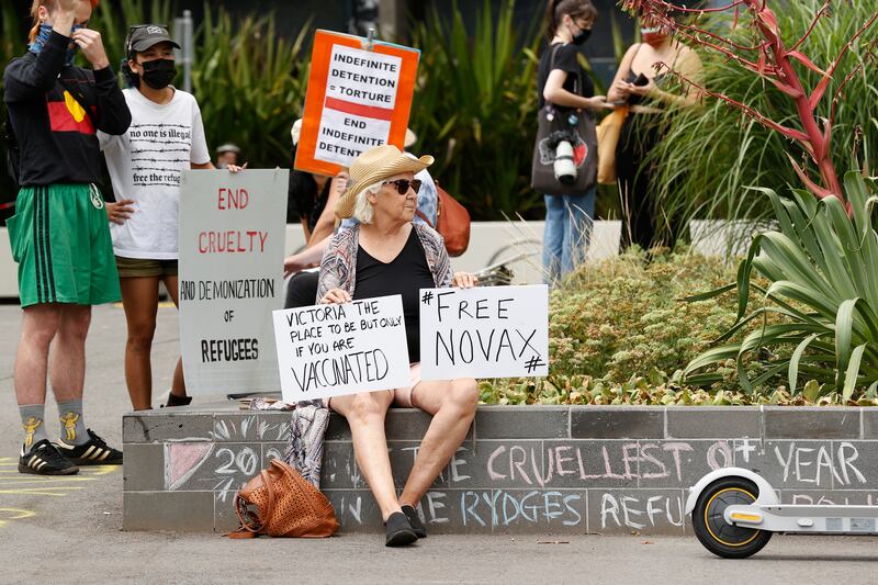 A tennis fan holds a sign outside the Park Hotel in Carlton, Melbourne on January 06, 2022, calling for Novak Djokovic to be released from quarantine. Getty Images