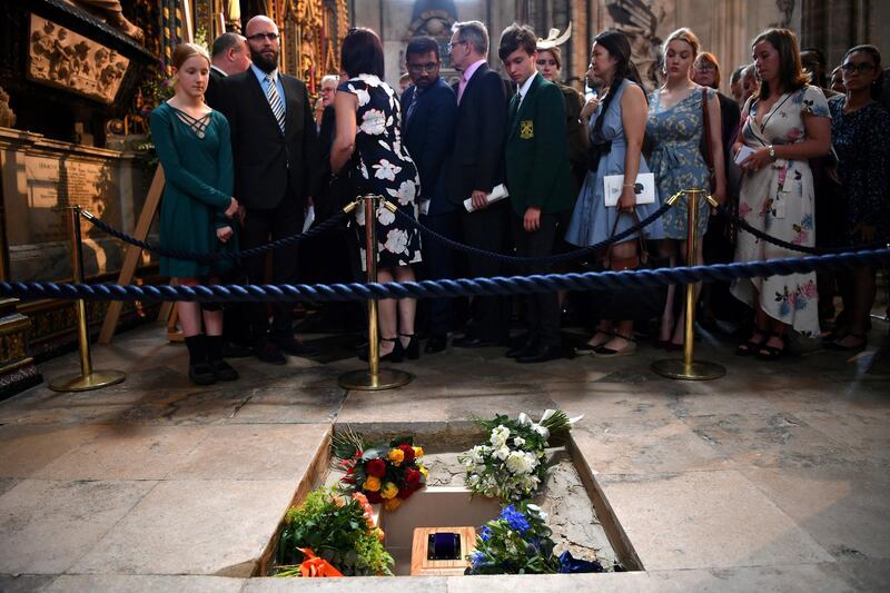 Members of the congregation file past the ashes of British scientist Stephen Hawking at the site of their interment in the nave of the Abbey church, during a memorial service at Westminster Abbey, in London, Britain, June 15, 2018. Ben Stansall/Pool via REUTERS