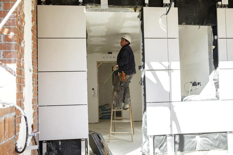A worker stands on a ladder at a construction site of a residential block in the Valdebebas neighbourhood. Spanish construction accounts for 5 per cent of the country’s output compared to 10 per cent in the boom years, or an annual shortfall of about 50 billion euros ($62 billion), and employs less than half than before the housing crash of 2008, with no quick prospect of a sharp rebound. Andrea Comas / Reuters