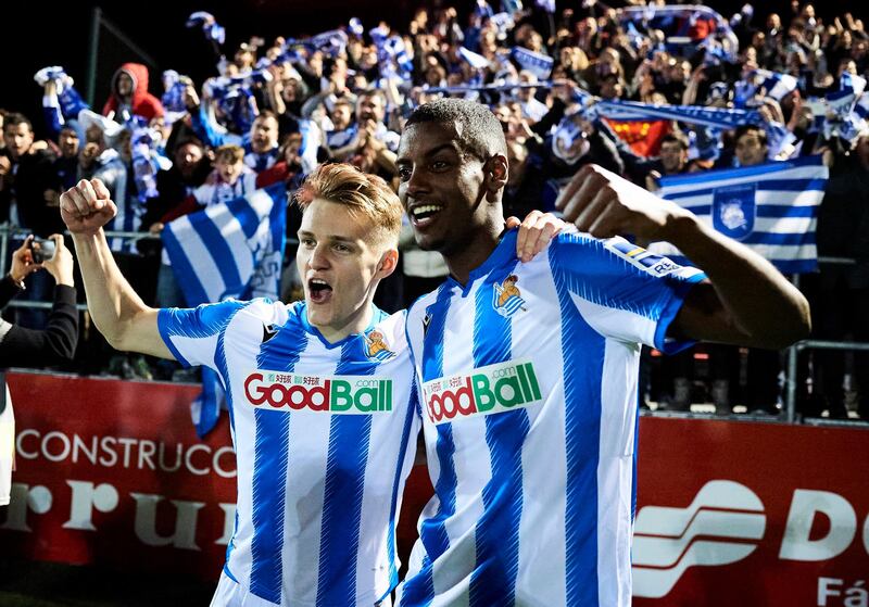 MIRANDA DE EBRO, SPAIN - MARCH 04: Martin Odegaard and Alexander Isak of Real Sociedad celebrate the qualifying  to the final with their fans during the Copa del Rey semifinal 2nd leg match between Mirandes and Real Sociedad at Estadio Municipal de Anduva on March 04, 2020 in Miranda de Ebro, Spain. (Photo by Juan Manuel Serrano Arce/Getty Images)