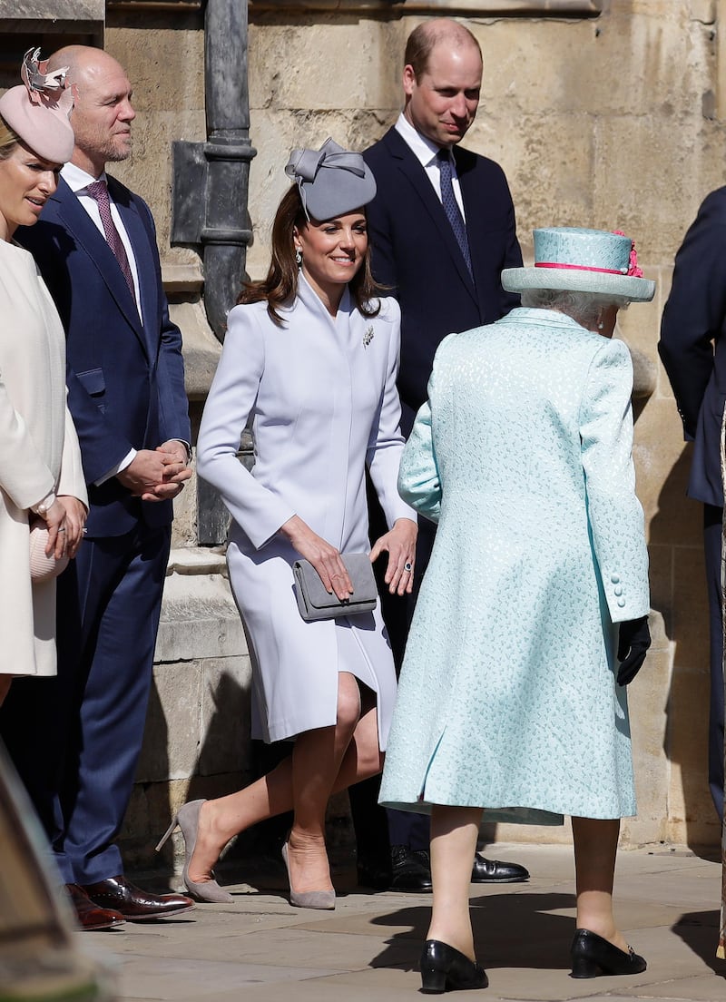 Catherine, Duchess of Sussex curtsies as Queen Elizabeth II arrives for the Easter Sunday service at St George's Chapel in Windsor, England. Getty Images