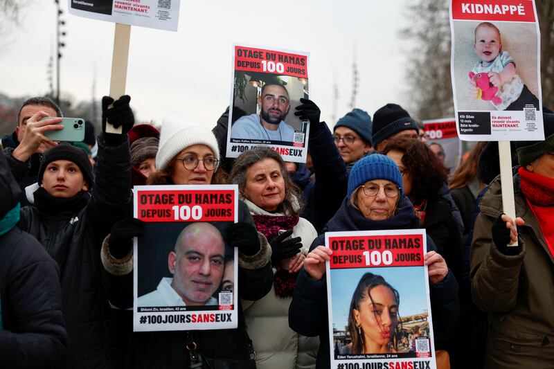 Marchers in Paris hold posters depicting Israeli hostages in Gaza on January 14. Reuters