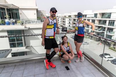 DUBAI, UNITED ARAB EMIRATES. 28 MARCH 2020. Colin Allin and his wife Hilda along with their daughter Geena pose at their “Start” section of their balcony marathon at their apartment in the Meydan Polo Residence. Colin and his wife Hilda are running a marathon on their balcony while the City of Dubai is under a Stay At Home policy to keep residence safe from the spread of Covid-19. (Photo: Antonie Robertson/The National) Journalist: Patrick Ryan. Section: Business.