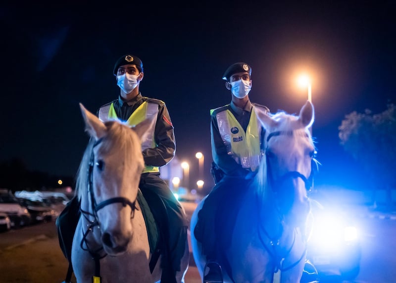 DUBAI, UNITED ARAB EMIRATES. 16 APRIL 2020. Dubai Mounted Police officers, in Al Aweer, patrol residential and commercial areas to insure residents are staying safe indoors during COVID-19 lockdown. They patrol the streets from 6PM to 6AM.The officers of the Dubai Mounted Police unit have been playing a multifaceted role in the emirate for over four decades. The department was established in 1976 with seven horses, five riders and four horse groomers. Today it has more than 130 Arabian and Anglo-Arabian horses, 75 riders and 45 groomers.All of the horses are former racehorses who went through a rigorous three-month-training programme before joining the police force. Currently, the department has two stables – one in Al Aweer, that houses at least 100 horses, and the other in Al Qusais, that houses 30 horses.(Photo: Reem Mohammed/The National)Reporter:Section: