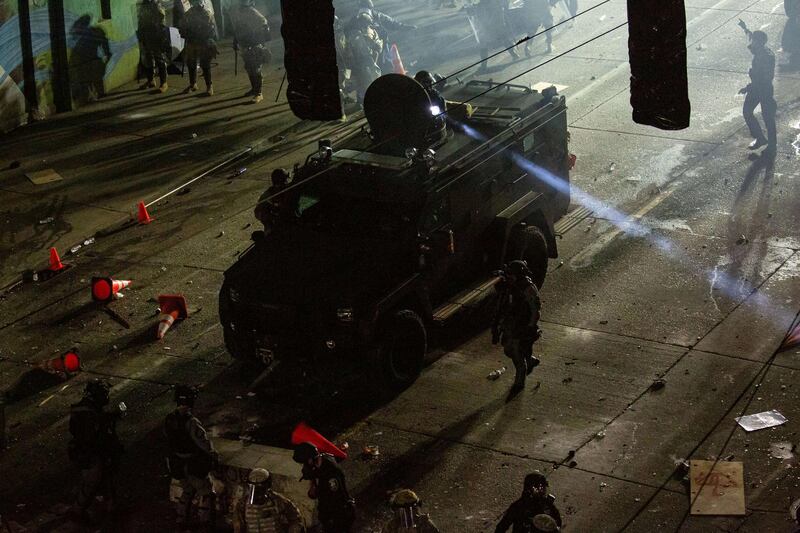 Seattle Police and Washington National Guard personnel retake control of an intersection as demonstrators clash with law enforcement near the Seattle Police Departments East Precinct shortly after midnight on June 8, 2020. Getty Images via AFP