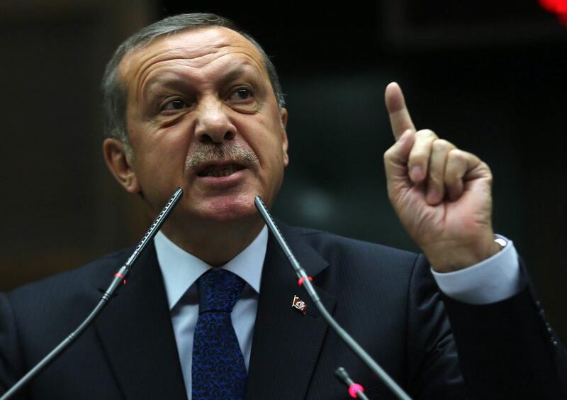 Turkey's President Recep Tayyip Erdogan talks to Justice and Development (AKP) party's members of parliament during a meeting at the Turkish parliament in Ankara. Adem Altan / AFP