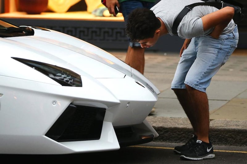 A car enthusiast looks at a Lamborghini Aventador, of the many curious fans who stop for a close look at these supercars. Dan Kitwood / Getty Images