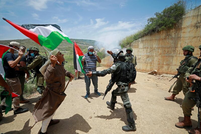Palestinians argue with Israeli troops during a protest marking the 72nd anniversary of Nakba and against Israeli plan to annex parts of the occupied West Bank, in the village of Sawiya near Nablus May 15, 2020. Reuters
