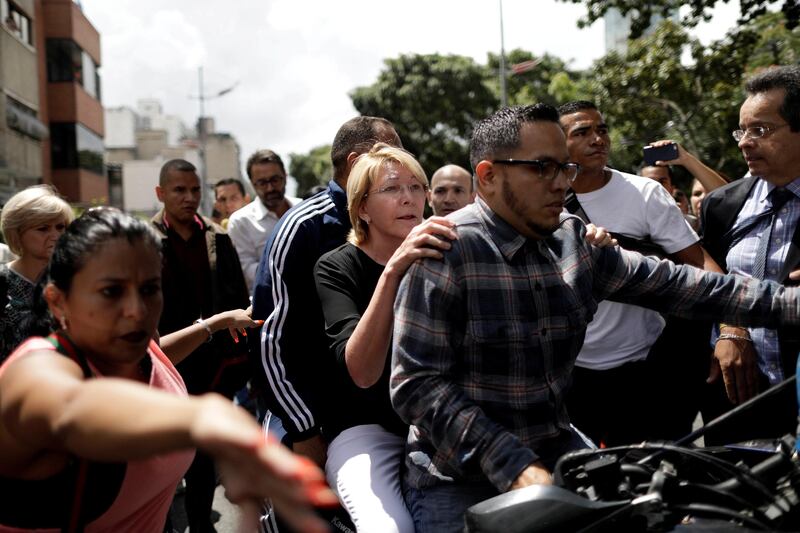 Venezuela's chief prosecutor Luisa Ortega is seen on a motorbike after a flash visit to the Public Prosecutor's office in Caracas, Venezuela August 5, 2017. REUTERS/Ueslei Marcelino     TPX IMAGES OF THE DAY