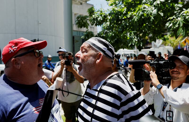 An anti-Trump demonstrator argues with a Trump supporter outside the courthouse. Reuters