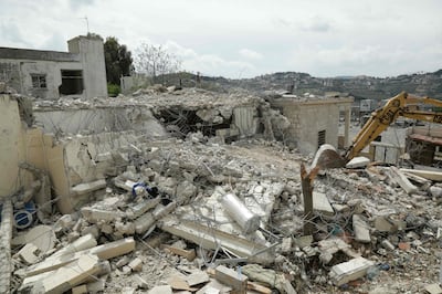 A bulldozer removes rubble from the site of an Israeli strike on a house in southern Lebanon on April 8. AFP