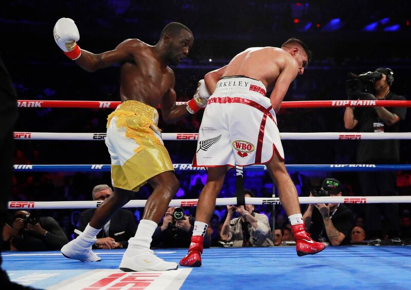 Amir Khan, left, reels after being hit by an accidental low blow by Terence Crawford. Action Images via Reuters