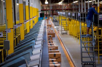 (FILES) In this file photo taken on August 1, 2017  boxes travel on conveyor belts at the Amazon Fulfillment Center in Robbinsville, New Jersey. - Amazon became the second big US company to hit $1 trillion in stock market value in the latest demonstration of the rising clout of American technology heavyweights September 4, 2018. The online retail giant breached the $1 trillion valuation near 1540 GMT when it's share price hit $2,050.50. The Amazon landmark comes about a month after Apple hit the $1 trillion level. (Photo by Mark Makela / GETTY IMAGES NORTH AMERICA / AFP)