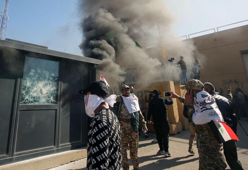 Smoke billows from a sentry box set on fire by an Iraq militia that is pro-Iran, in front of the US embassy building in the capital Baghdad. AFP