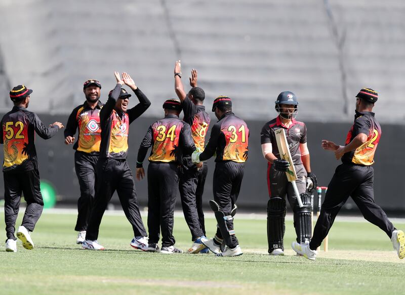 PNG's Alei Nao takes the wicket of UAE's Alishan Sharafu. Chris Whiteoak / The National