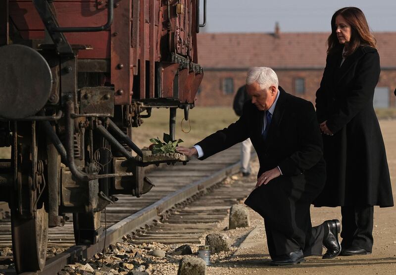 OSWIECIM, POLAND - FEBRUARY 15: U.S. Vice President Mike Pence and Second Lady Karen Pence lay flowers at a railway once car used to transport inmates at the Auschwitz-Birkenau concentration camp memorial on February 15, 2019 in Oswiecim, Poland. Pence is in Auschwitz following his participation in the recent Ministerial to Promote a Future of Peace and Security in the Middle East that took place in Warsaw. Auschwitz was among the most notorious of the Nazi concentration camps and was used by the Nazis to murder Jews on a mass scale. (Photo by Sean Gallup/Getty Images)