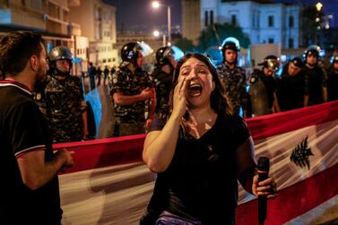 epa07565906 Lebanese Riot policemen stand guard where activists wave Lebanese flags and chant slogans during a protest in front the government palace in Beirut, Lebanon, 12 May 2019, during a government meeting. According to media reports, activists from the civil societies and retired military and security personnel continued their preemptive protest against any austerity measures in the 2019 draft state budget. EPA/NABIL MOUNZER