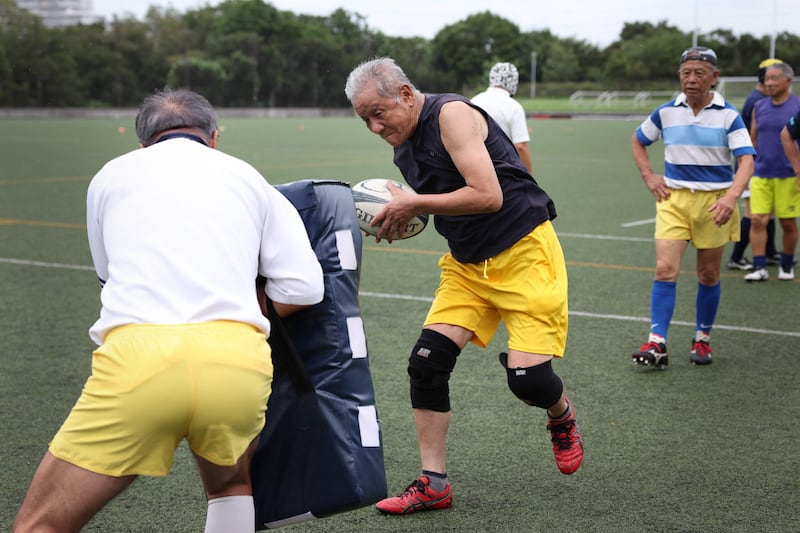 Players over the age of 70 during a training session at the Hodogaya Rugby Stadium in Yokohama