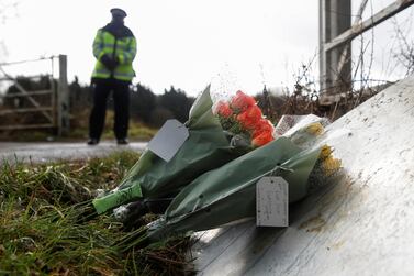 Flowers placed by police officers at the golf course entrance are pictured, as the investigation into the disappearance of Sarah Everard continues, in Ashford, Britain, March 11, 2021. REUTERS/Paul Childs