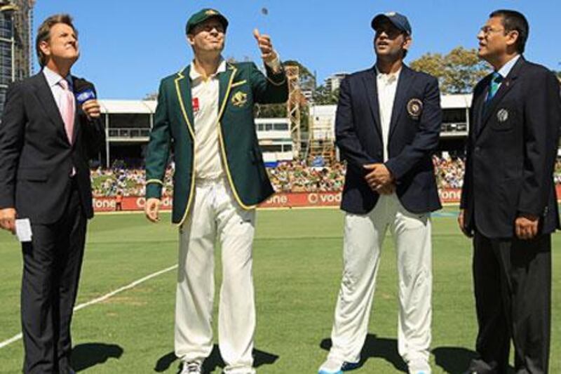 Australia's Michael Clarke, second from the left, tosses the coin as India's MS Dhoni, second from the right, and others look on. Tony Greig suggests that India has an 'apparent indifference' to Test cricket.