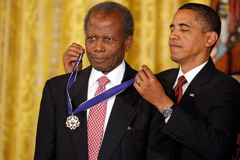 Barack Obama, the US president at the time, presents the Medal of Freedom to Sidney Poitier during a ceremony in the East Room of the White House in 2009. Getty Images