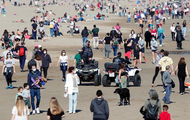 Two members of Valencia's local police patrol on quad bikes, at a crowded Malvarrosa beach in Valencia, eastern Spain. EPA