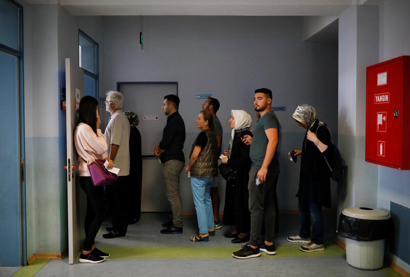 People wait to vote during Turkey's presidential and parliamentary elections at a polling station in Istanbul, Turkey, on June 24, 2018. Alkis Konstantinidis / Reuters