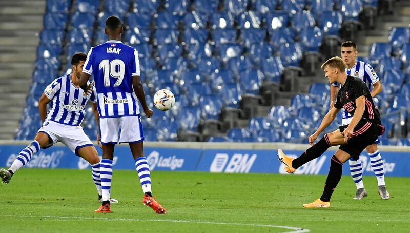 Martin Odegaard hits a pass during the Liga game between Real Sociedad and Real Madrid at the Anoeta Stadium. AP Photo