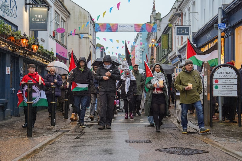 A walking vigil makes its way through the streets of Falmouth, England for aid worker James Henderson, who was killed in an Israeli air strike. Getty Images