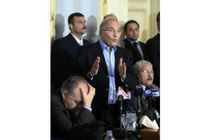 Egyptian Prime Minister Ahmed Shafiq talks during a press conference in Cairo, Egypt, Sunday, Feb.13, 2011. Egypt's military leaders dissolved parliament and suspended the constitution Sunday, meeting two key demands of protesters who have been keeping up pressure for immediate steps to transition to democratic, civilian rule after forcing Hosni Mubarak out of power. Seated at right, finance minister Samir Radwan, at left, interior minister, Mahmoud Wagdy. (AP Photo/Amr Nabil)