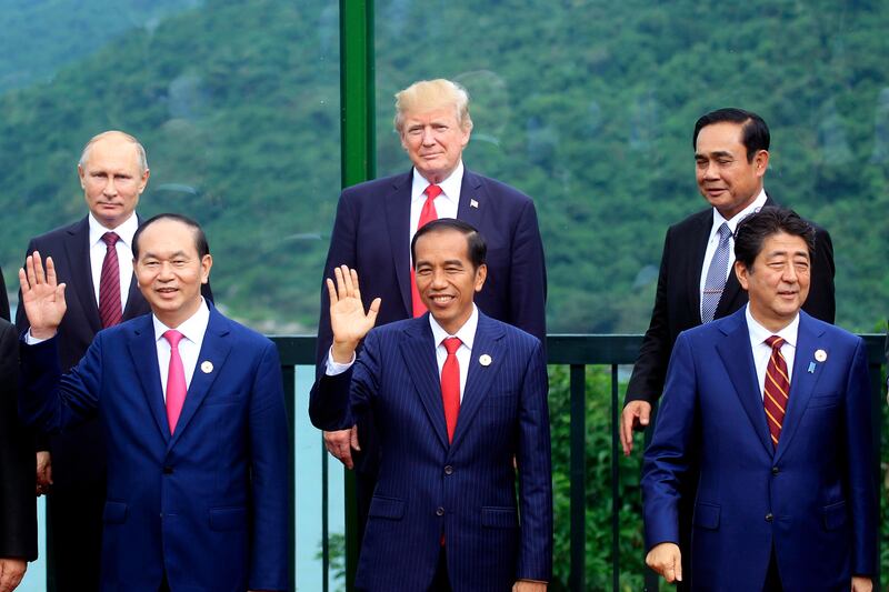 Leaders, back row from left, Russian President Vladimir Putin, U.S. President Donald Trump, Thai Prime Minister Prayuth Chan-ocha, front row from left, Vietnamese President Tran Dai Quang, Indonesian President Joko Widodo, and Japanese Prime Minister Shinzo Abe pose for a photo during the family photo session during the Asia-Pacific Economic Cooperation (APEC) Summit in Danang, Vietnam, Saturday, Nov. 11, 2017. President Trump stood before a summit of Asian leaders keen on regional trade pacts and delivered a roaring "America first" message Friday, denouncing China for unfair trade practices just a day after he had heaped praise on President Xi Jinping in Beijing. (AP Photo/Hau Dinh)