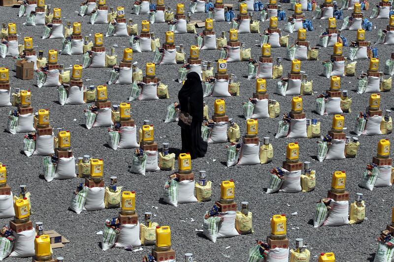 epaselect epa07573925 A woman walks amongst food rations provided by a local charity to conflict-affected people, in Sanaâ€™a, Yemen, 05 May 2019 (Issued 15 May 2019). According to reports, around 20 million people of Yemen's 26-million population are in need of urgent humanitarian assistance as a result of increased food insecurity, more than four years of the escalating conflict in the Arab country.  EPA/YAHYA ARHAB