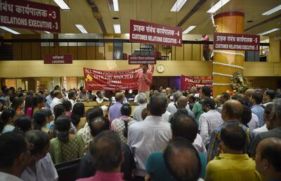 Indian Punjab National Bank workers stage a protest inside a branch in Mumbai on May 30, 2018. 
Nearly one million Indian public sector and regional rural bank employees are staging a two-day nationwide strike, demanding wage revisions. / AFP PHOTO / PUNIT PARANJPE