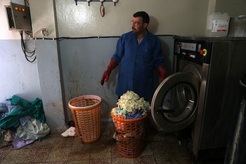 epaselect epa06292052 (17/30) A man takes medical gloves out of a washing machine, rebel-held Douma, besieged Eastern al-Ghouta, Syria, 21 October 2017. Due to the siege on eastern al-Ghouta, nurses inside Damascus Countryside Specialized Hospital started washing gloves, surgical suture, and ventilation tubes, and then sterilize these tools by using formaldehyde, before the seige in normal situations, these tools are thrown away and replaced after each operation. Rebel-held Eastern al-Ghouta, located 15km outside of Damascus and home for more than 400 thousand people, has been under siege by forces loyal to the Syrian government for four years.  EPA/MOHAMMED BADRA ATTENTION: For the full PHOTO ESSAY text please see Advisory Notice epa06292035