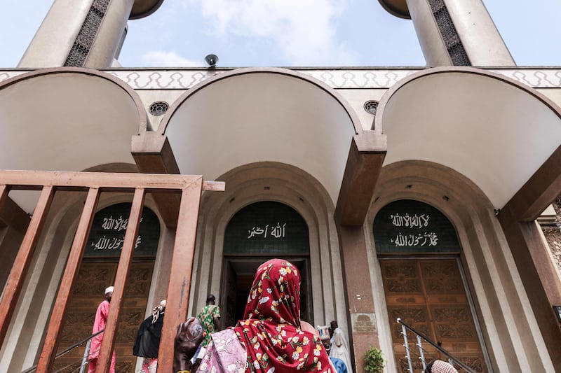A woman stands in front of the Lagos Central Mosque in Lagos.  AFP