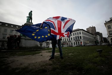 A Remainer unfurls the UK and EU flags outside the European Parliament in Brussels earlier this year. UK PM Boris Johnson believes the two entities can maintain excellent relations despite the split. AP Photo