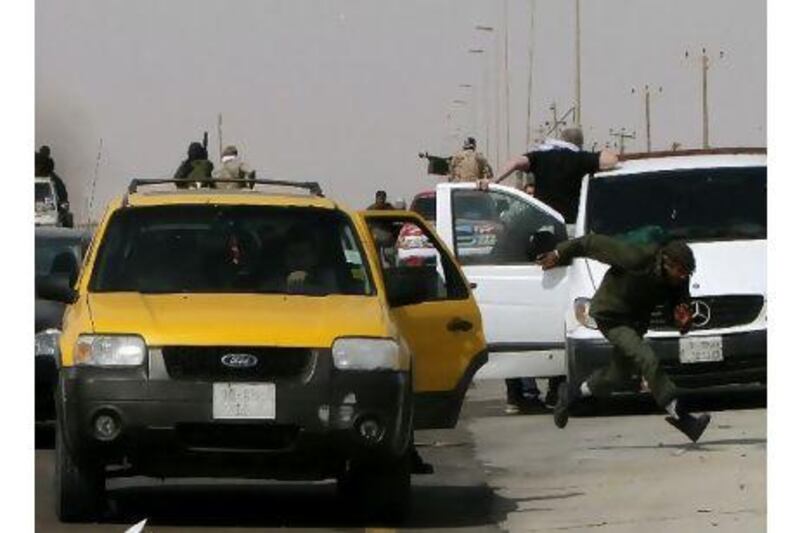 Libyan rebels flee Ras Lanuf as they come under fire from loyalist forces yesterday while world powers debated arming the fighters seeking to oust Muammar Qaddafi.