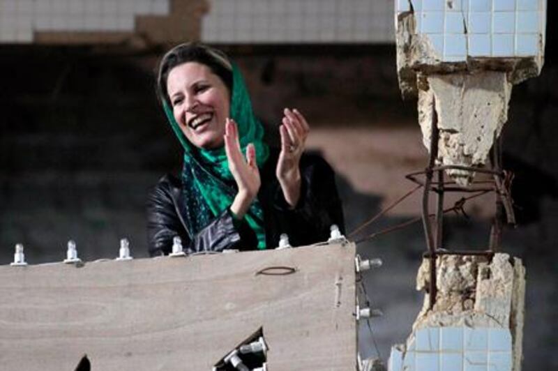 EDITOR'S NOTE: PICTURE TAKEN ON GUIDED GOVERNMENT TOUR
Aisha Gaddafi, daughter of Libya's leader Muammar Gaddafi, gestures during a pro-government rally at the heavily fortified Bab al-Aziziya compound in Tripoli, in this file picture taken April 14, 2011. Gaddafi's wife Safia and daughter Aisha crossed the border into Tunisia, Reuters reported on May 18, 2011, a Tunisian security source as saying, but it was unclear whether they were on a diplomatic mission or seeking safe haven. Arabic television stations quoted Tunisian officials as denying that the family members were in the country, saying that Safia Gaddafi and her daughter Aisha were on a U.N. sanctions list and would therefore not be allowed in. 
However, the security source said the two women came to Tunisia with a Libyan delegation on May 14, 2011 and have been staying on the southern island of Djerba near the Libyan border.     REUTERS/Louafi Larbi/Files (LIBYA - Tags: POLITICS CIVIL UNREST) *** Local Caption ***  SIN70_LIBYA-_0518_11.JPG